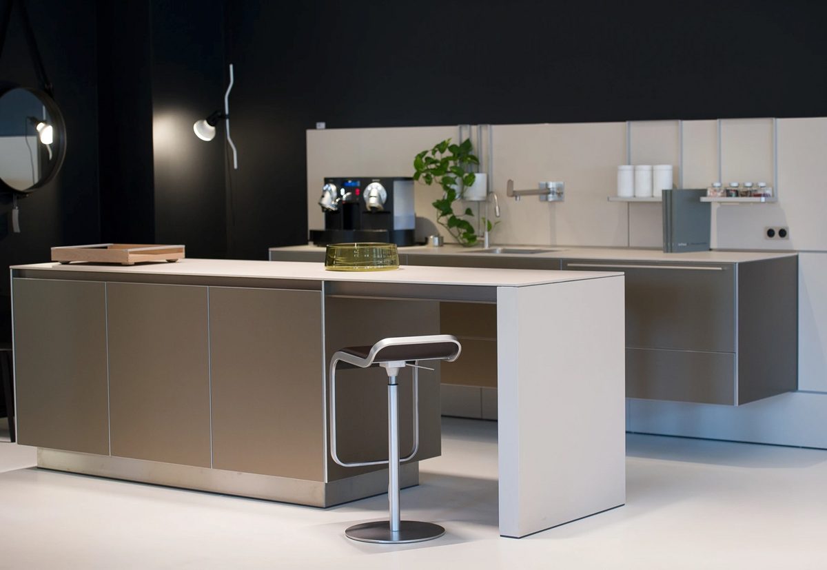 Grifflose moderne Kuecheninsel mit Barhocker vor dunkler Wand — Das Studiozwei, Werbefotograf München