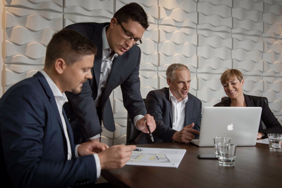 Team bei einer Praesentation mit Laptop am Konferenztisch — Das Studiozwei, Werbefotograf München