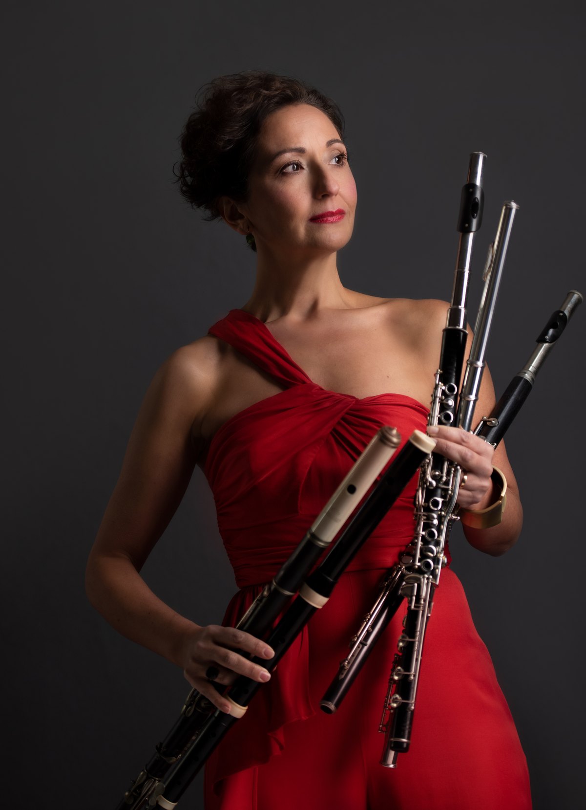 Musikerin im roten Kleid mit mehreren Holzblasinstrumenten — Das Studiozwei, Werbefotograf München