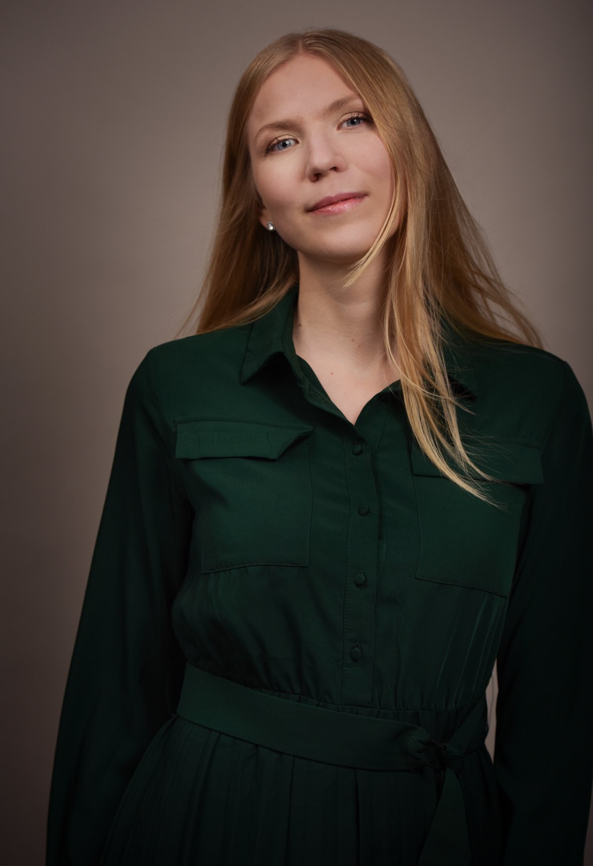Frau im gruenen Hemdblusenkleid vor dunklem Hintergrund — Das Studiozwei, Werbefotograf München
